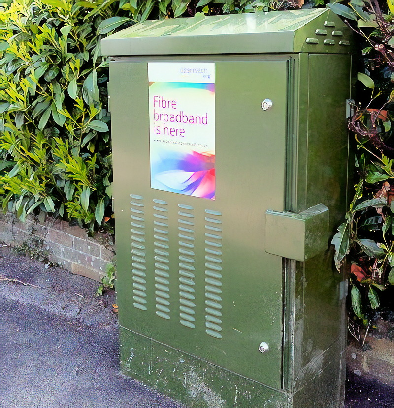 Photo of green metal box at edge of pavemente